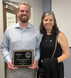 Joe Hansen hold Nelson Award while standing next to mentor Dr. Ruth Carmichael