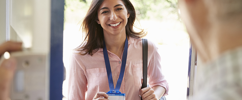 Woman showing her badge as she walks into an office.