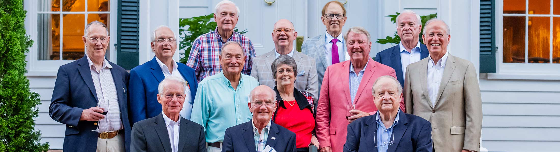 College of Medicine Alumni standing on porch.