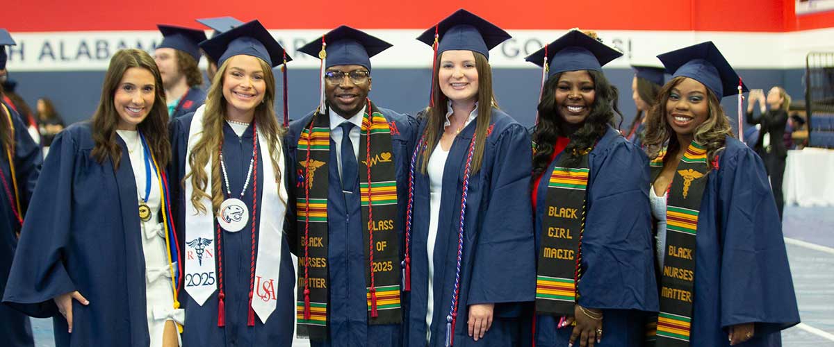 Nursing students in cap and gowns at graduation.