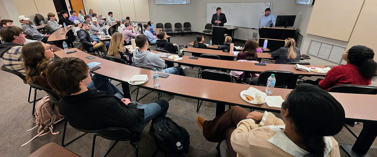 Real Estate students sitting in classroom listening to presentation.