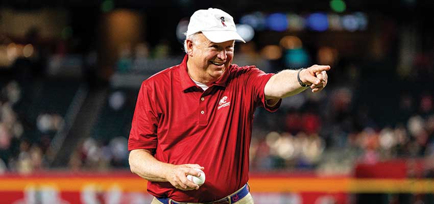 PRESIDENT JO BONNER throws the game’s ceremonial first pitch to Arizona Diamondbacks Hall of Famer and USA Trustee Luis Gonzalez during an alumni and friends event Aug. 13 at Chase Field. data-lightbox='featured'
