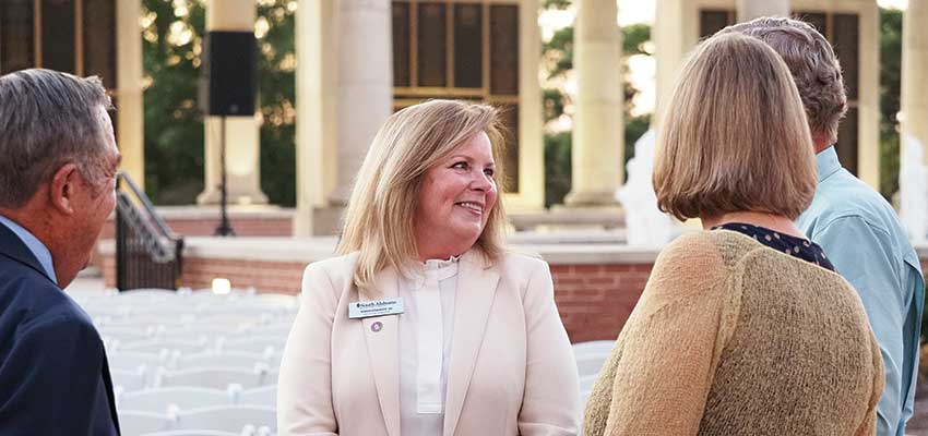Karen Edwards and other alumni at Moulton Tower. data-lightbox='featured'