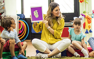 Teacher teaching two kids