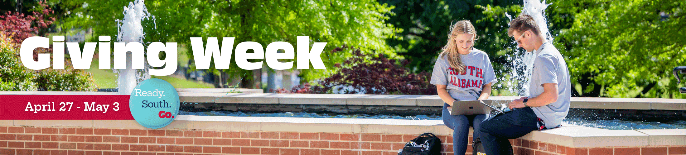 Giving Week April 27 - May 3 with students looking at laptop in front of fountain.