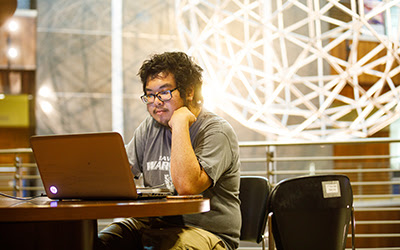 Student working on his laptop 