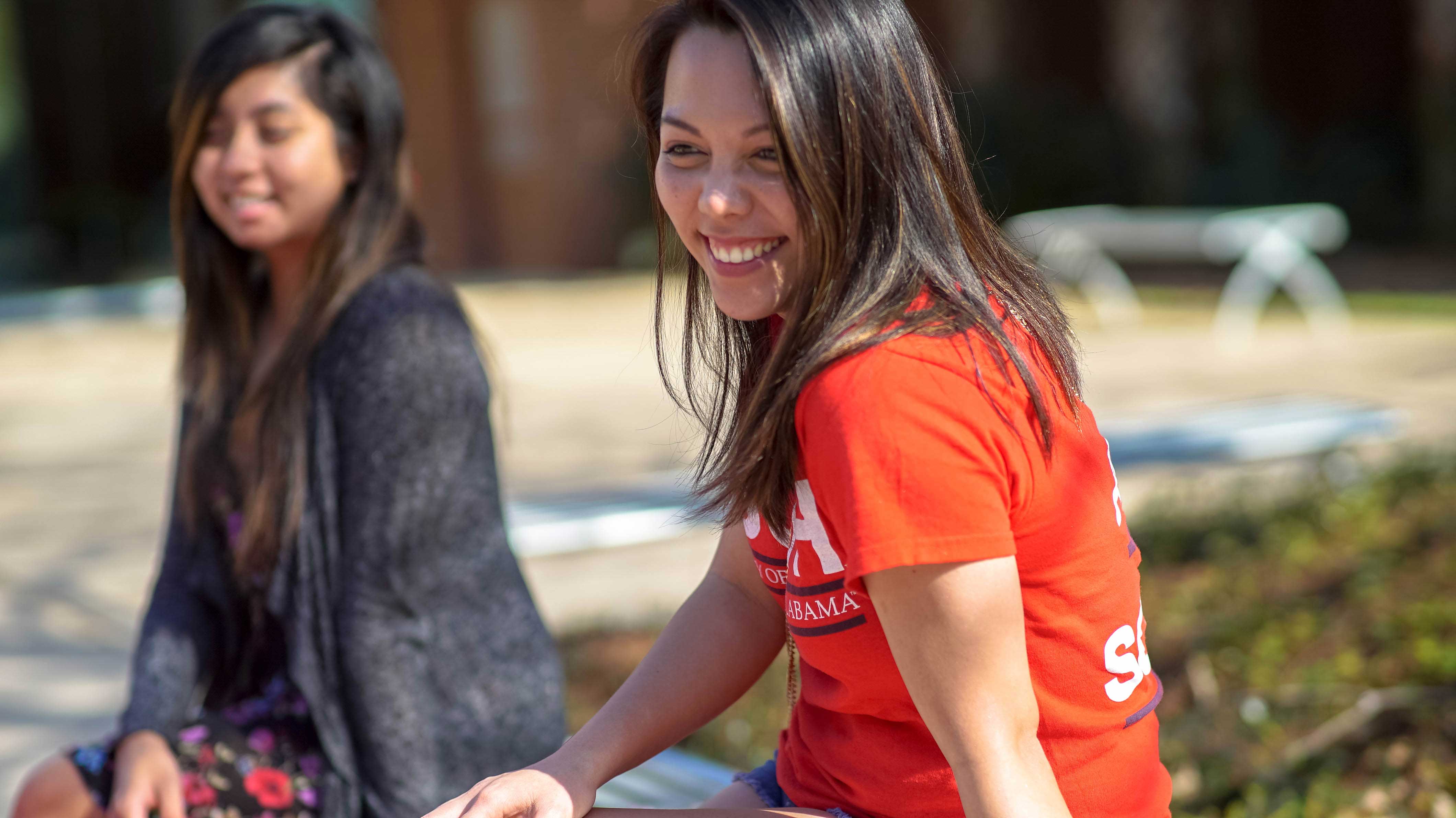 Place Holder Two students sitting outside smiling