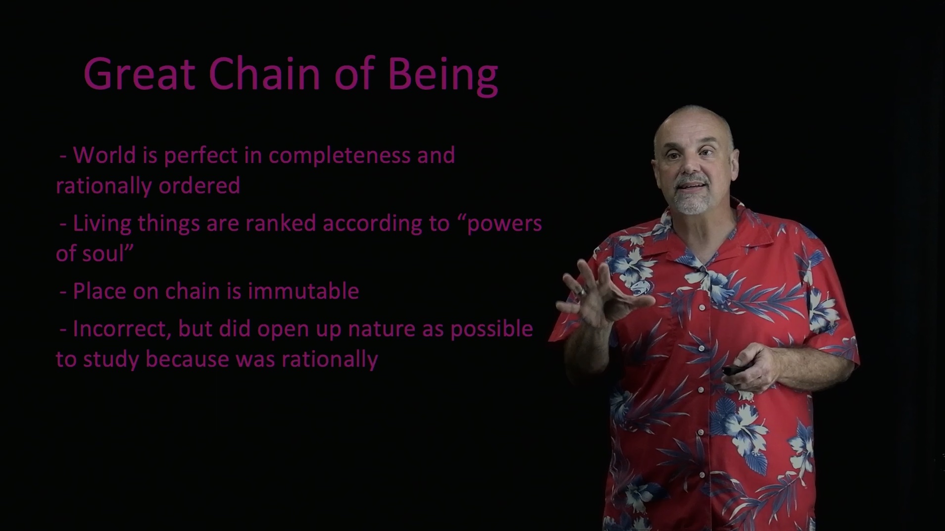 freeze frame clip from a video of a man talking with text on screen next to him