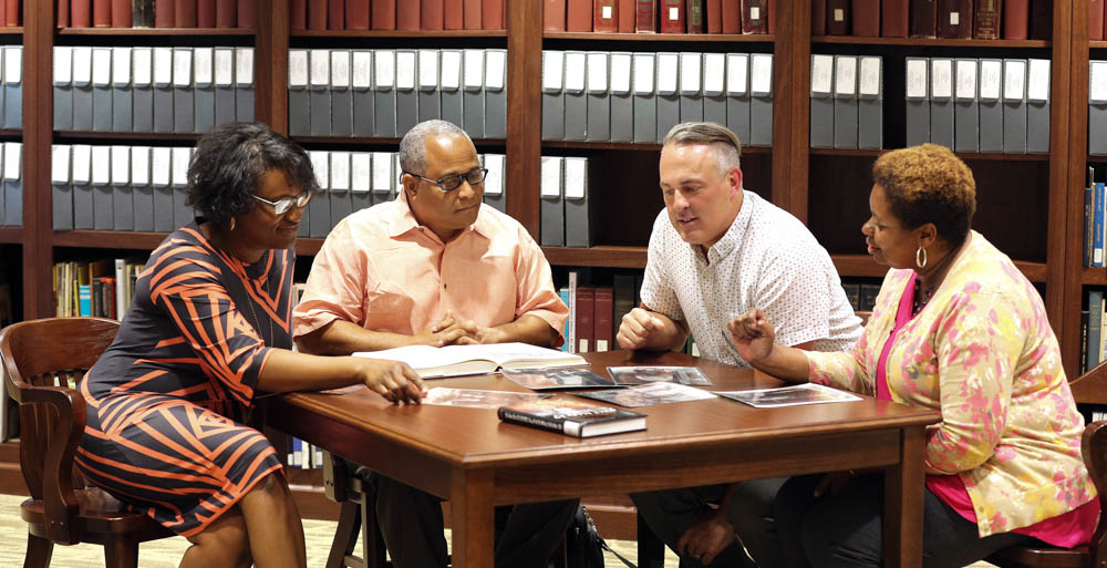 The life and legacy of Clotilda survivors of Africatown will be included in the first feature documentary film with the collaborative efforts of faculty from the University of South Alabama and Spring Hill College. Discussing resources for the documentary are, from left, Dr. Joel’ Lewis Billingsley, producer; Dr. Kern Jackson, co-producer; Ryan Noble, director; and Dr. Pamela R. Moore, co-producer. data-lightbox='featured'