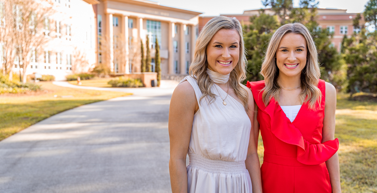 Logan, left, and Mallorie Collins, twin sisters from Satsuma, Alabama, share a residence hall suite, a major in mechanical engineering and a spirit for cheering on the Jaguars. data-lightbox='featured'