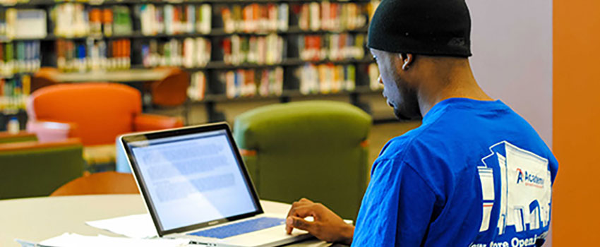 Student smiling looking at laptop