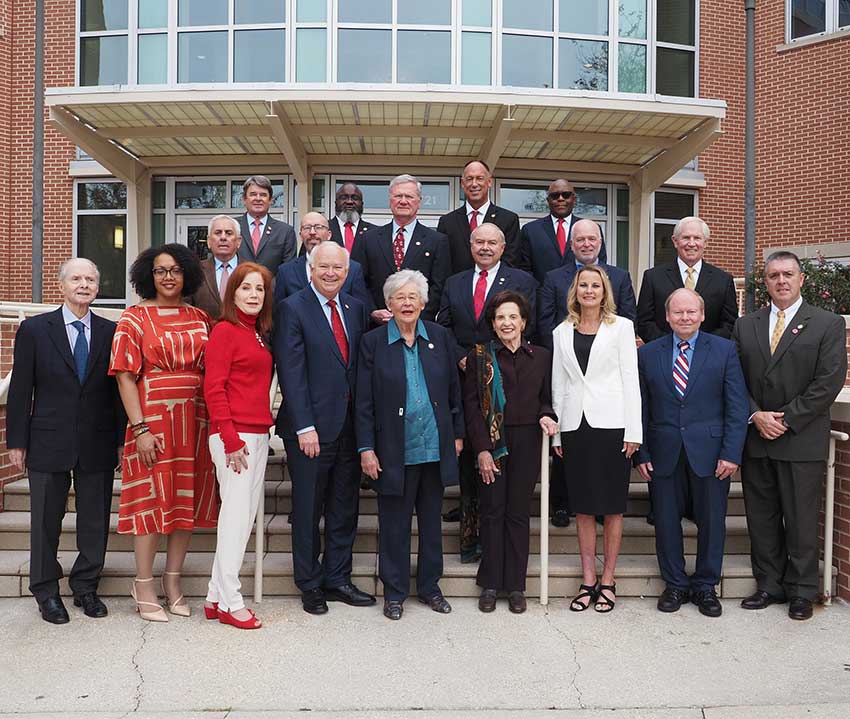 Pictured from the left: Honorary Trustee Abe Mitchell with Trustees Dr. Steve Furr; Dr. Scott Charlton; Ron Jenkins; Chandra Brown Stewart; Jimmy Shumock; Jim Yance; Ken Simon - Chair pro tempore; Ron Graham; Governor Kay Ivey - ex officio President and Chair; Dr. Steve Stokes; Tom Corcoran; Lenus Perkins; Arlene Mitchell; Mike Windom; Alexis Atkins and Margie Tuckson; and President Tony Waldrop.