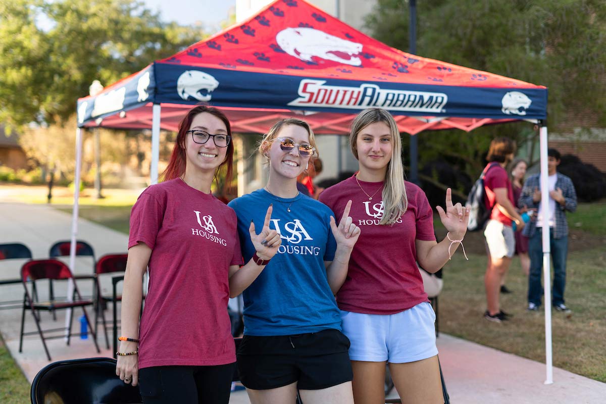 USA housing tent tailgate with students holding 'J' USA housing tent tailgate with students holding 'J'